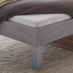 Bett in Betonoptik mit Kopfteil Kissen - Rienas