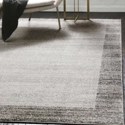 Teppich in Hellgrau mit dunkelgrauem Rand - Armina